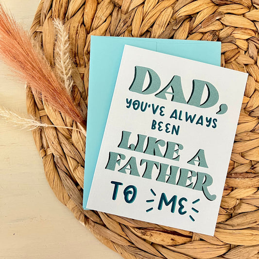 Greeting card with text 'Dad, you've always been like a father to me' on a woven mat.