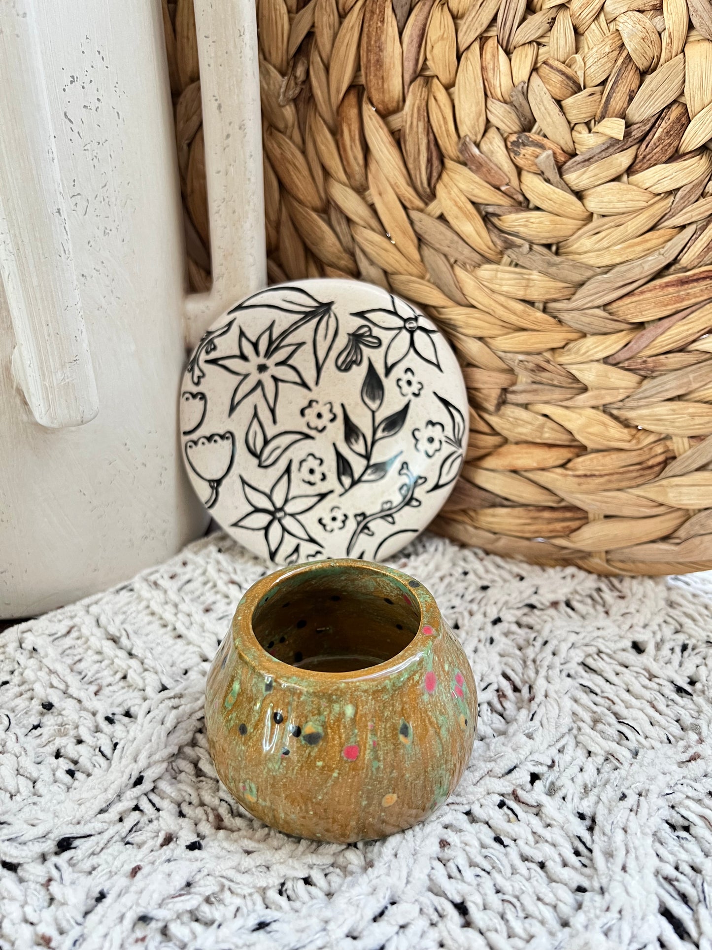 Ceramic mushroom box with decorative pattern on a textured surface