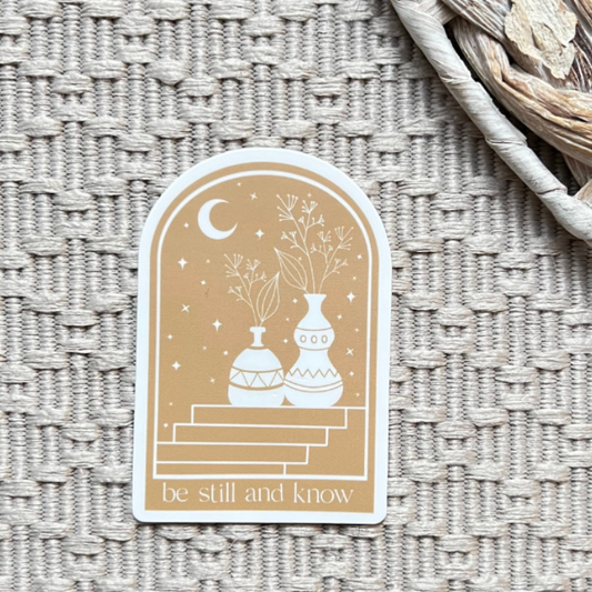Decorative sticker with vases and text 'be still and know' on a textured surface