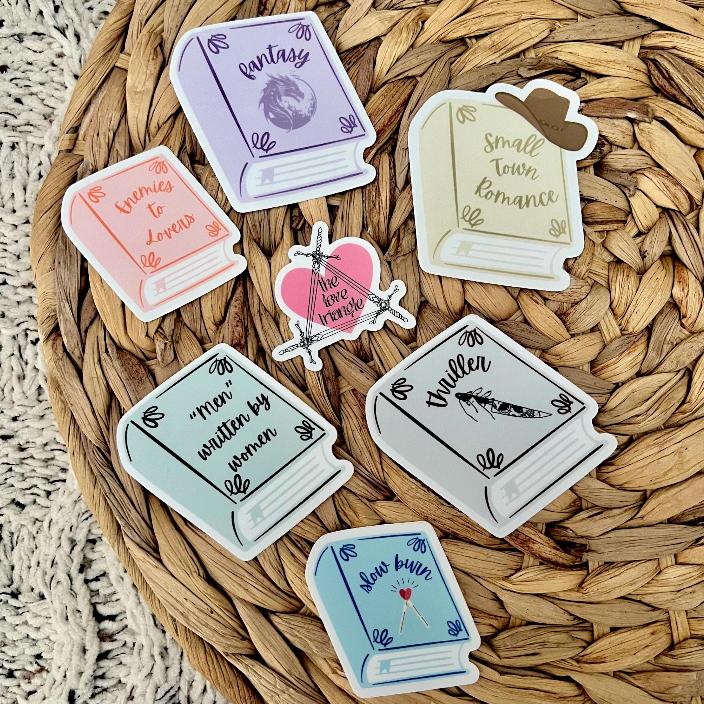 Set of book-themed stickers on a woven surface