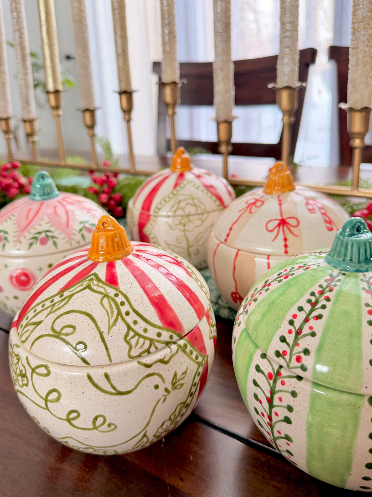 Decorative ceramic bulbs with colorful designs on a table.