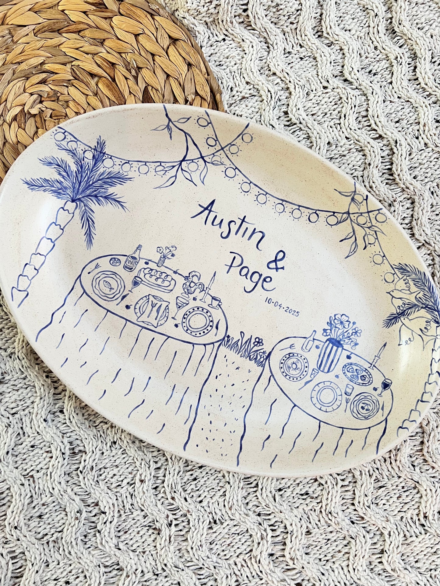 Decorative ceramic tray with blue designs and text on a textured surface
