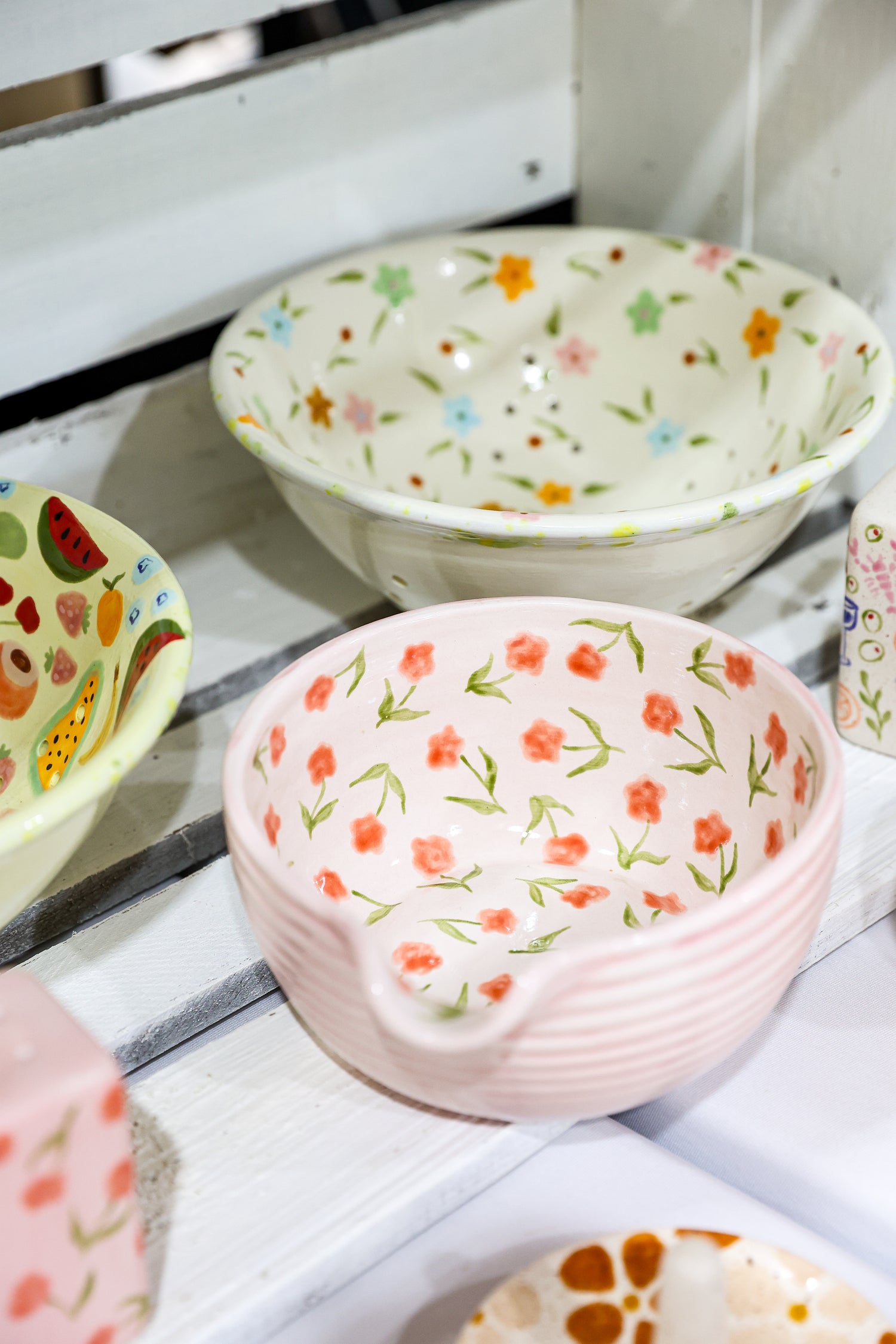 Set of ceramic bowls with floral patterns on a white surface