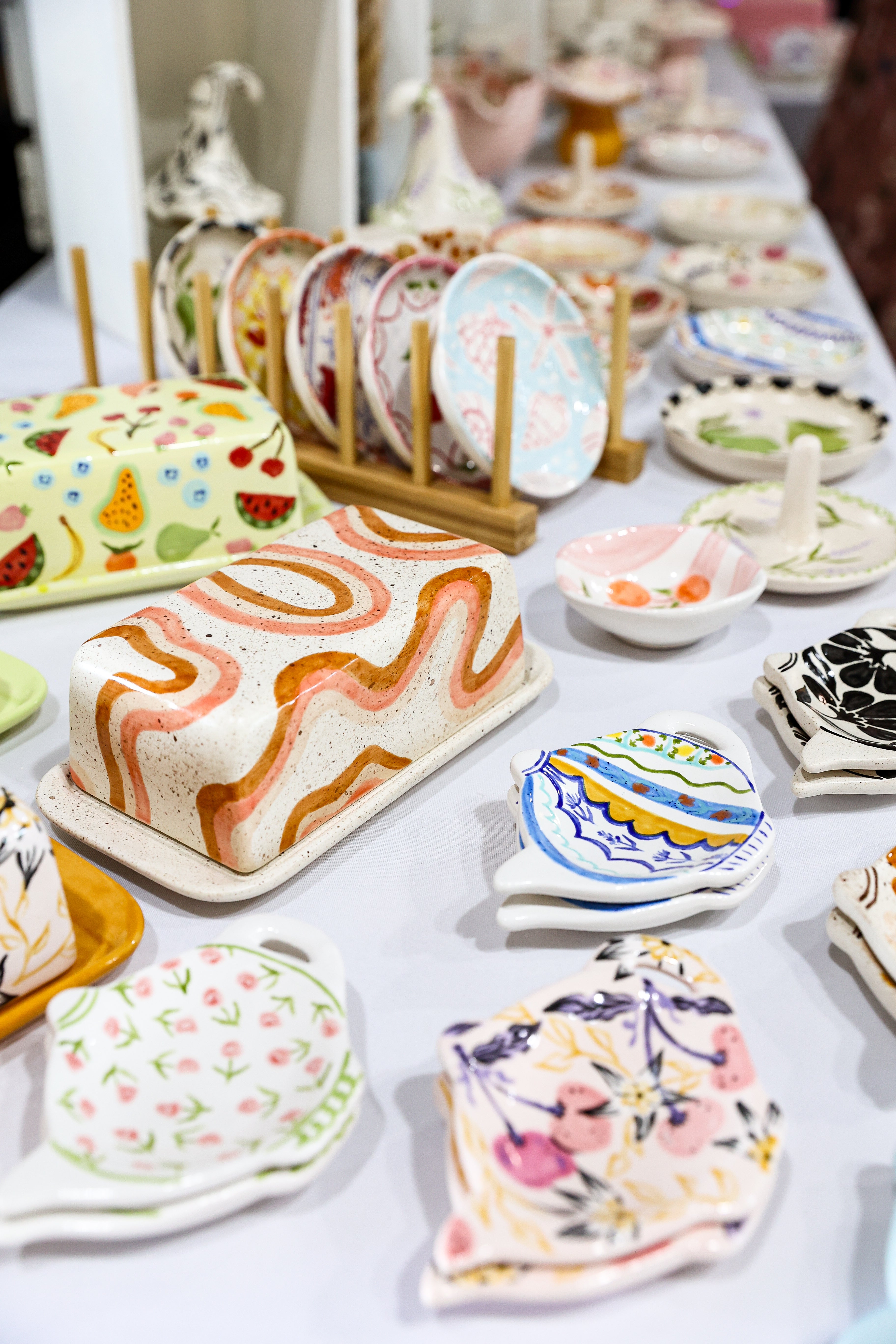 Collection of colorful ceramic plates and trays on a table