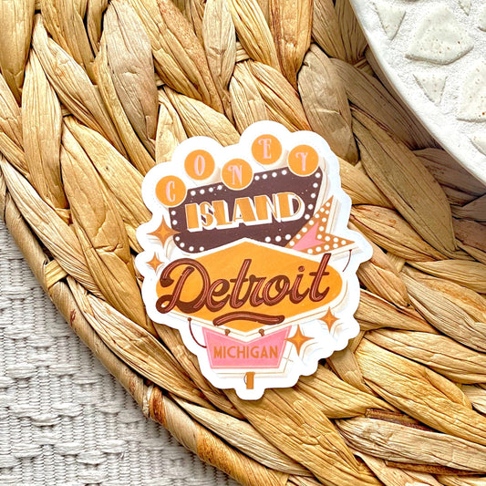 Sticker with 'Coney Island Detroit Michigan' written on a vintage sign design on a woven mat