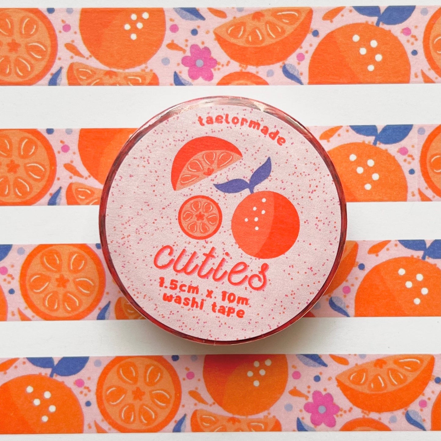 Washi tape with orange design and 'Cuties' branding on a white background