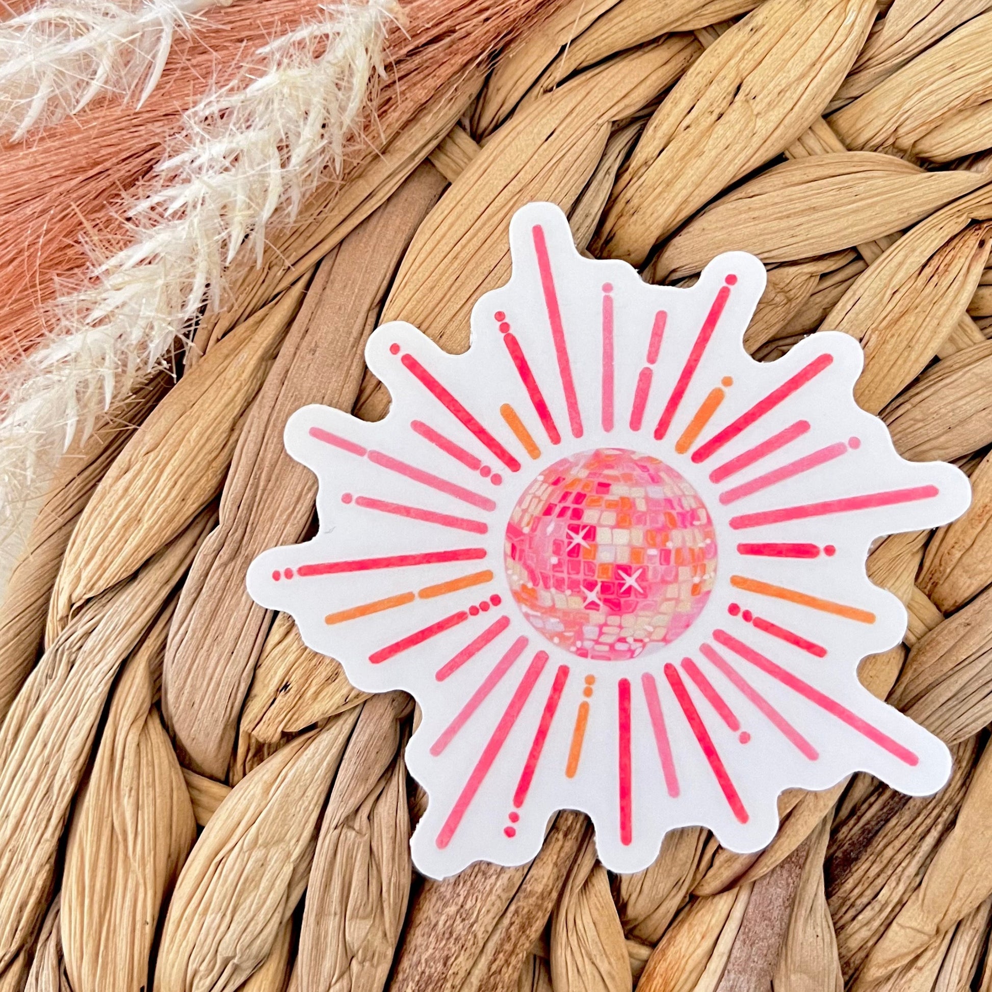 Decorative sticker with sunburst disco ball design on a woven surface