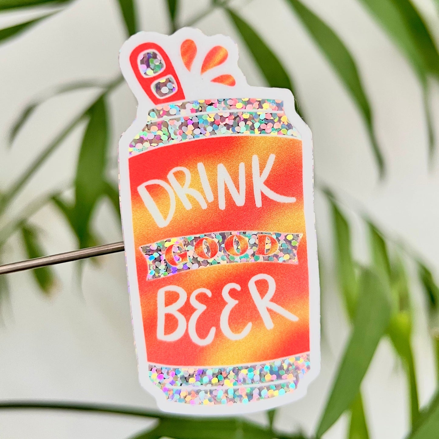 Colorful 'Drink Good Beer' sticker with a leafy green background