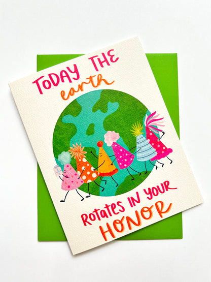 Card with cartoon characters of birthday hats around the Earth and text on a white background