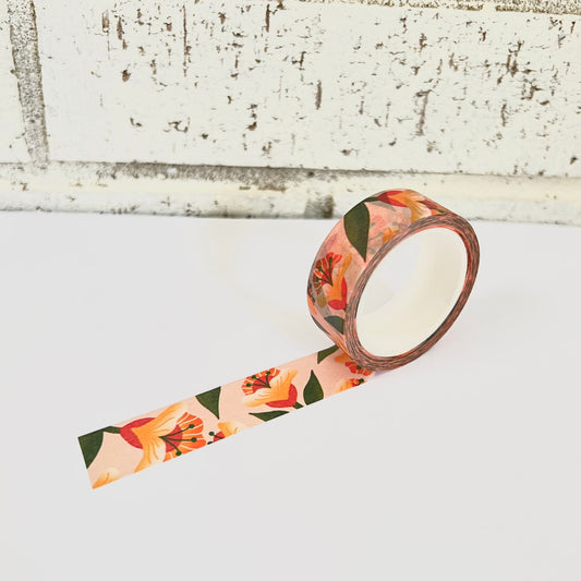 Floral-patterned tape on a white surface with a rustic wooden background