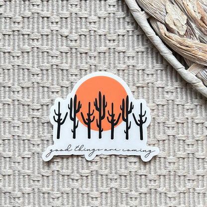 Sticker with cacti and sun design on a textured surface