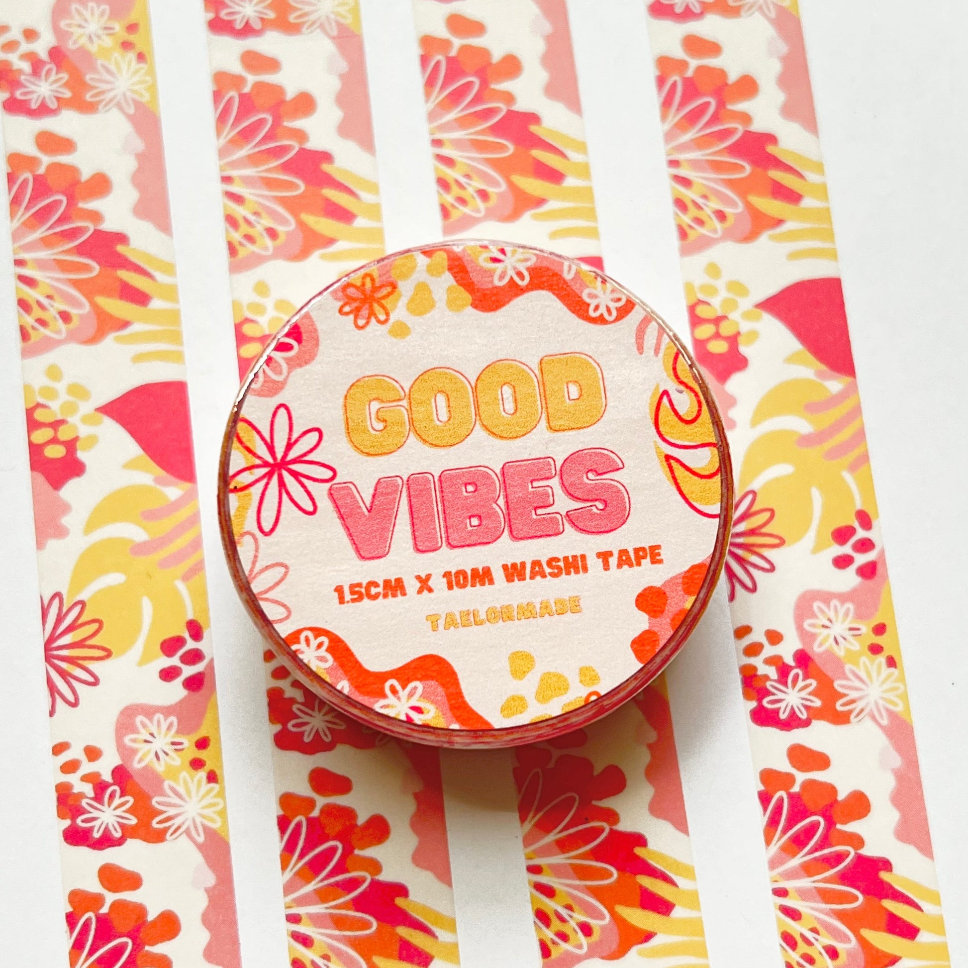 Decorative washi tape with 'Good Vibes' text on a colorful floral background