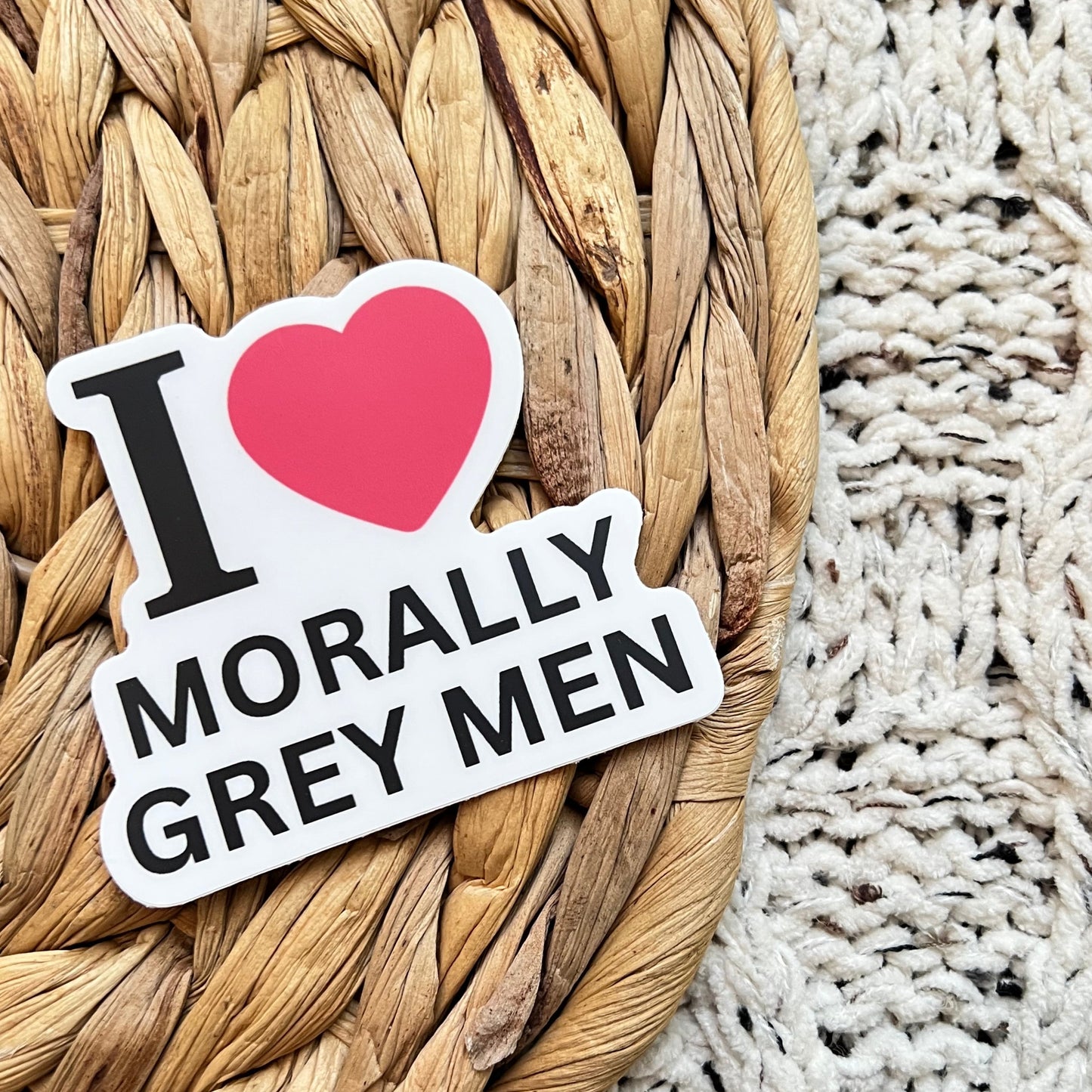 Sticker with text 'I ❤️ Morally Grey Men' on a woven mat