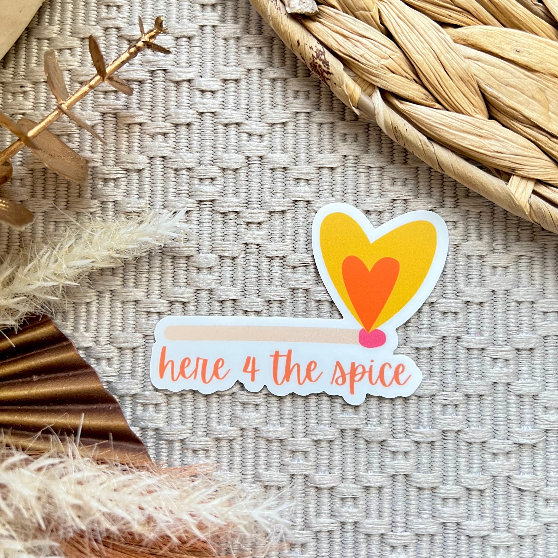 Sticker of a match lighting a heart shaped fire and text 'here 4 the spice' on a textured surface with decorative elements.