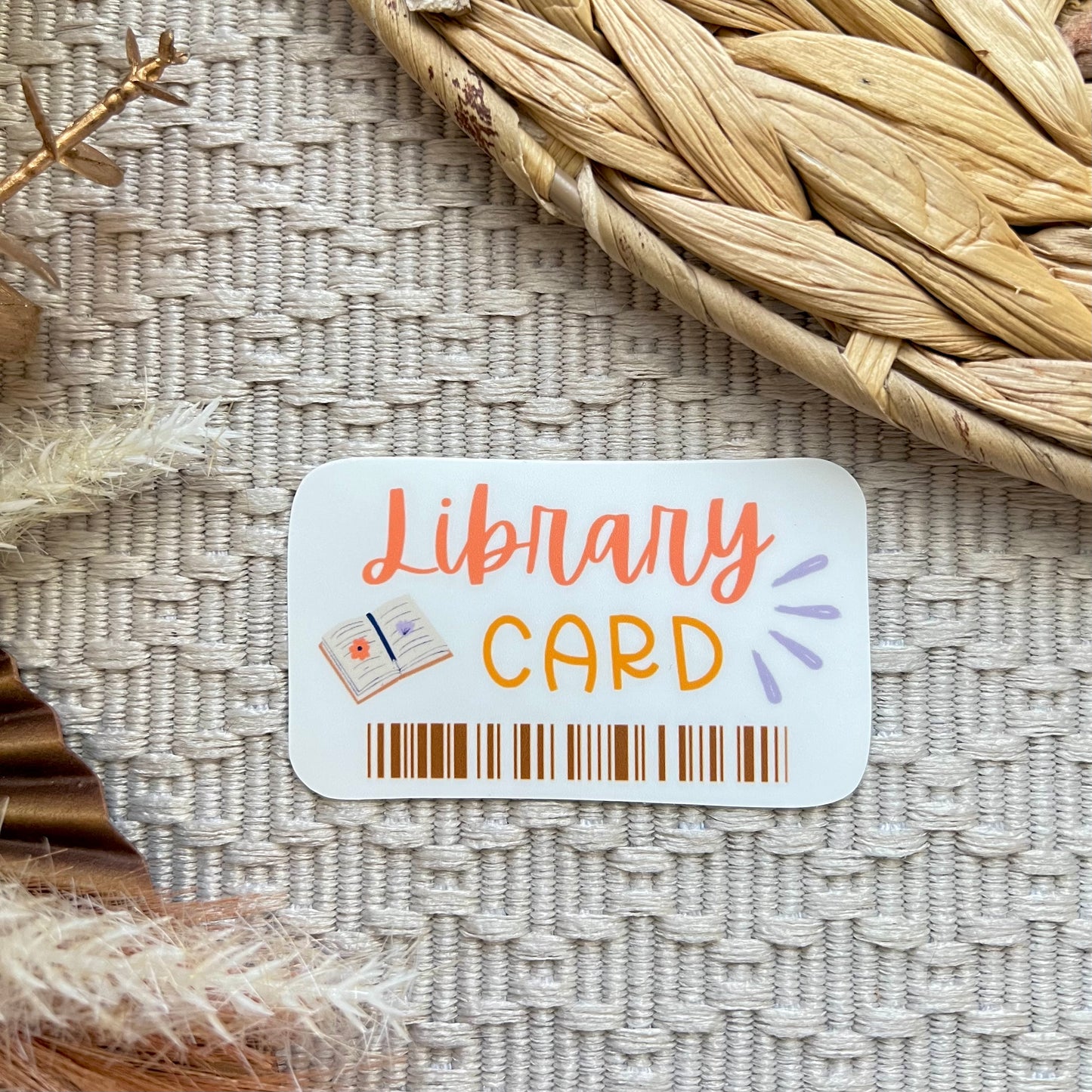 Library card sticker on a textured surface with decorative elements