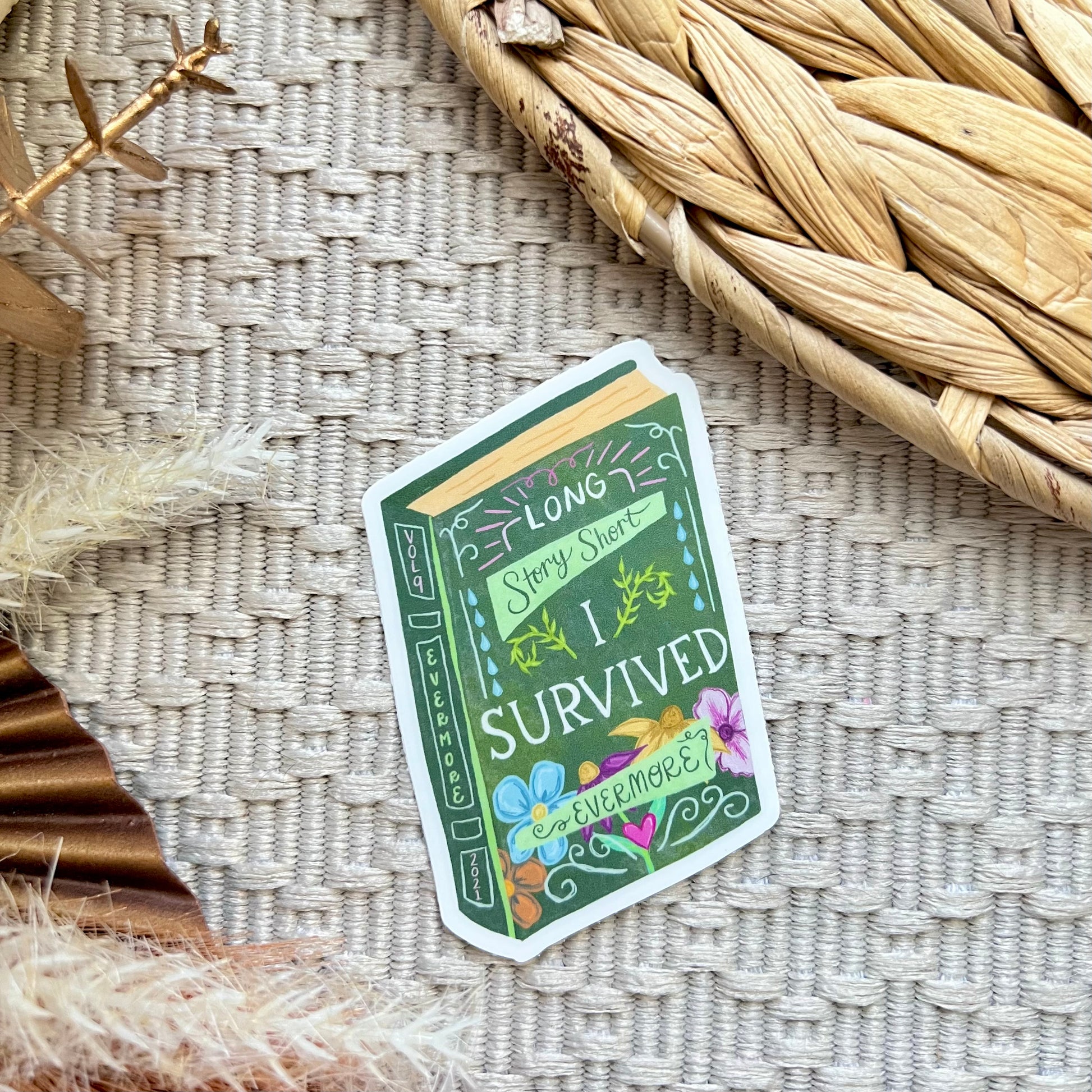 Sticker with 'I Survived' design written on a book on a textured surface