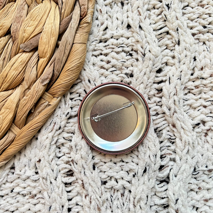 Michigan button pin on a textured fabric surface