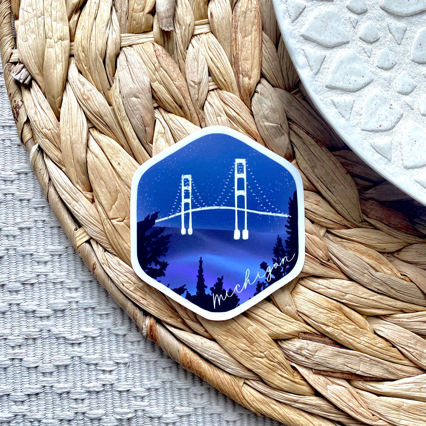 Hexagonal sticker with a bridge design on a woven mat