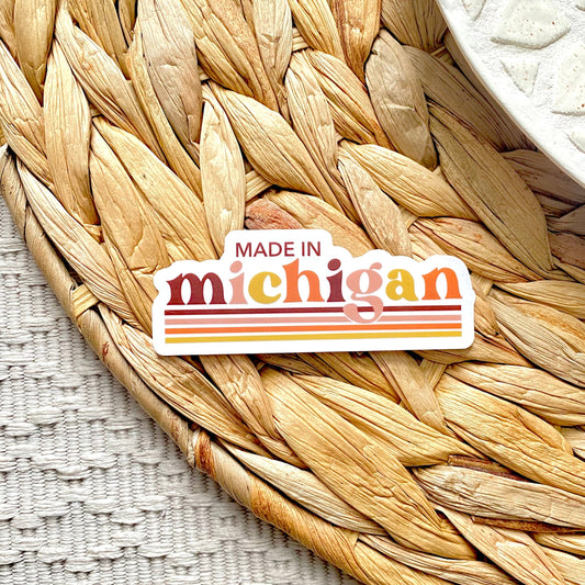 Sticker with 'Made in Michigan' text on a woven mat
