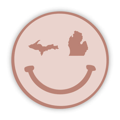 Smiley face design with Michigan outline on a pink background