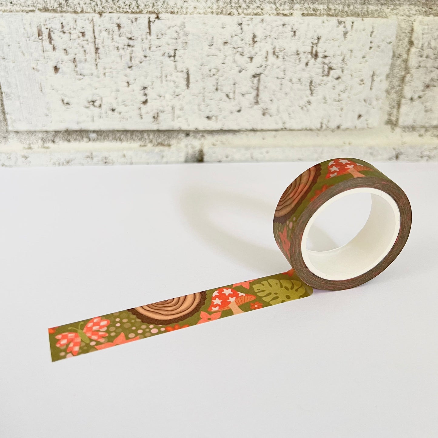 Decorative tape with floral pattern on a white surface against a textured wall background