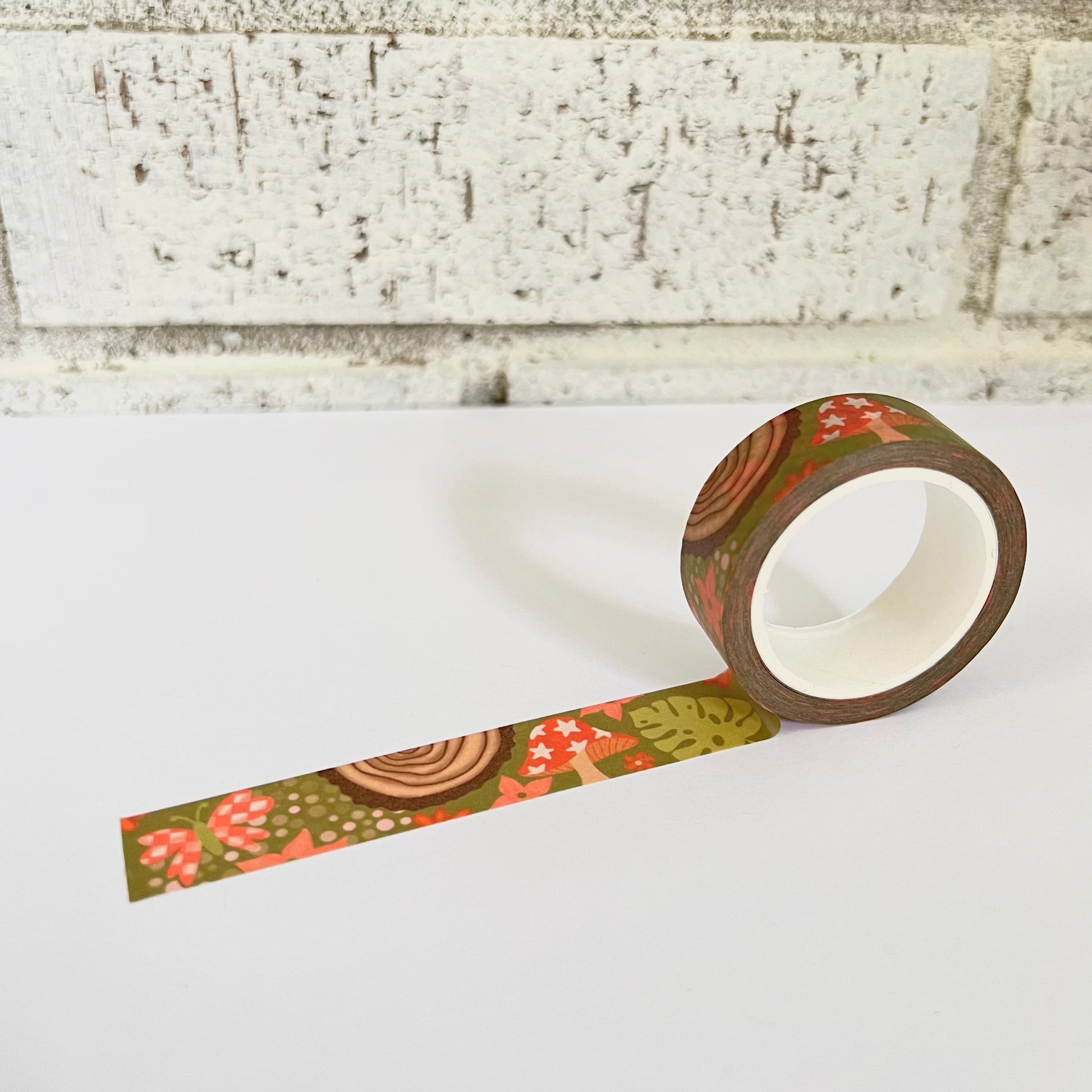 Decorative tape with floral pattern on a white surface against a textured wall background