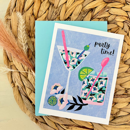 Greeting card with floral cocktail design and 'party time!' text on a woven mat
