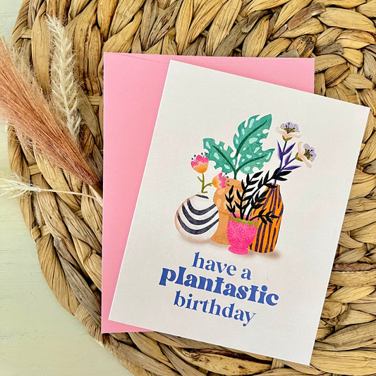 Greeting card with plant illustrations and text on a woven mat