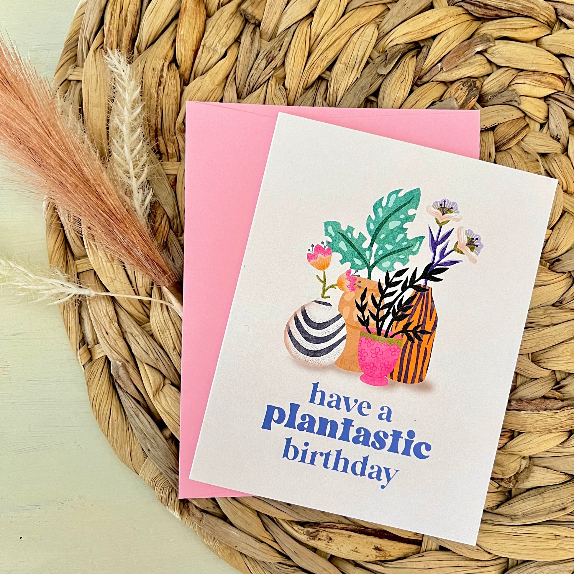 Greeting card with plant-themed design and 'have a plantastic birthday' text on a woven mat.