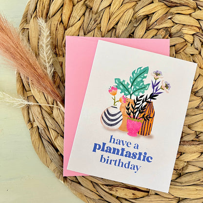 Greeting card with plant-themed design and 'have a plantastic birthday' text on a woven mat.