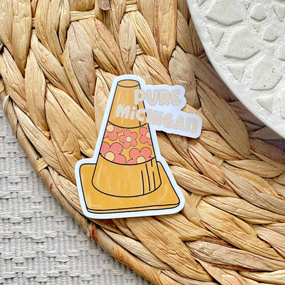 Sticker of a traffic cone with 'Pure Michigan' text on a woven mat