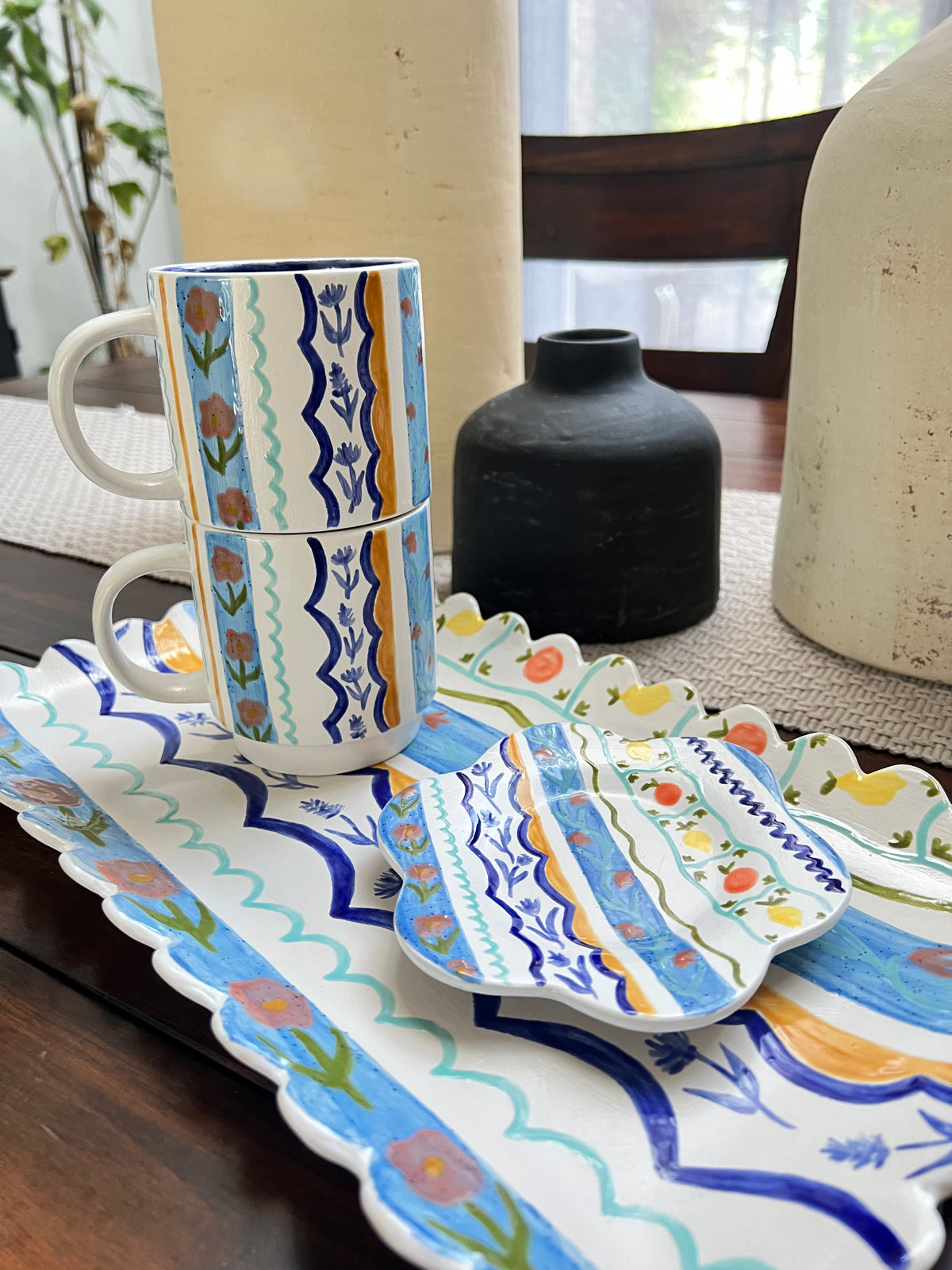 Set of ceramic dishes with floral patterns on a table.