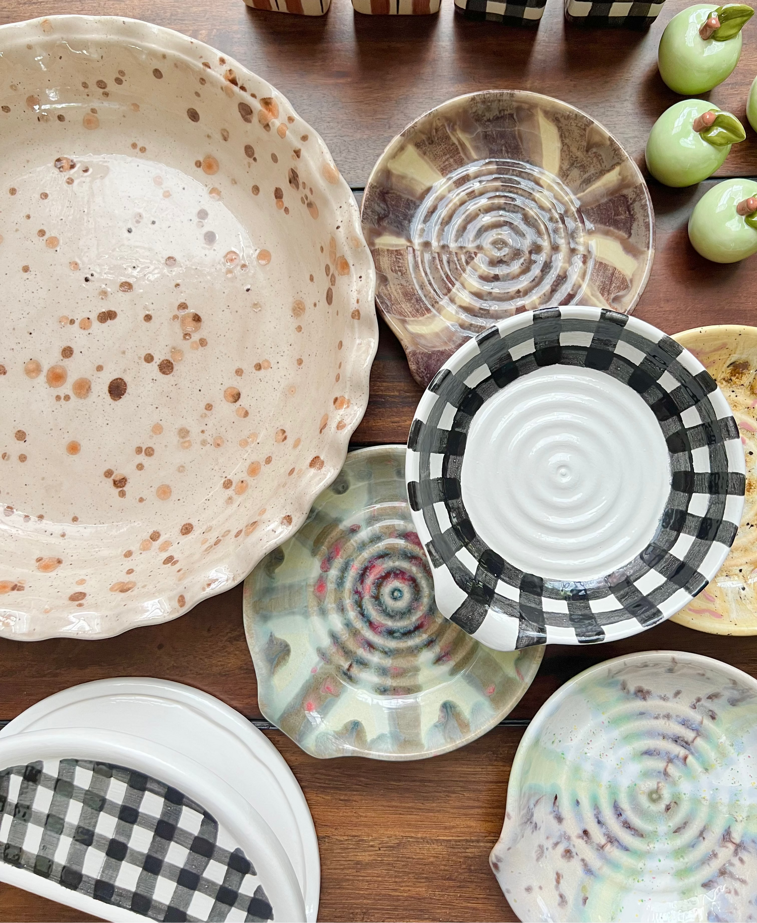 Collection of ceramic plates with various patterns on a wooden surface
