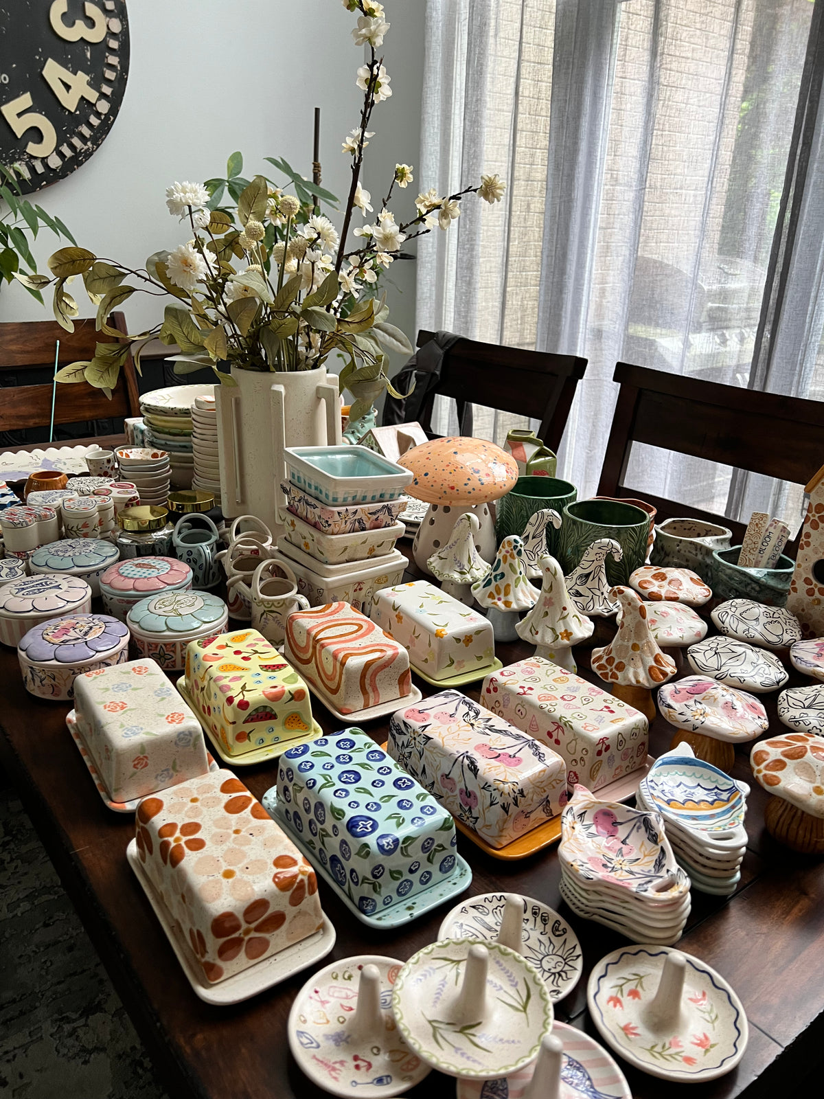 Collection of small ceramic items on a table with a window in the background