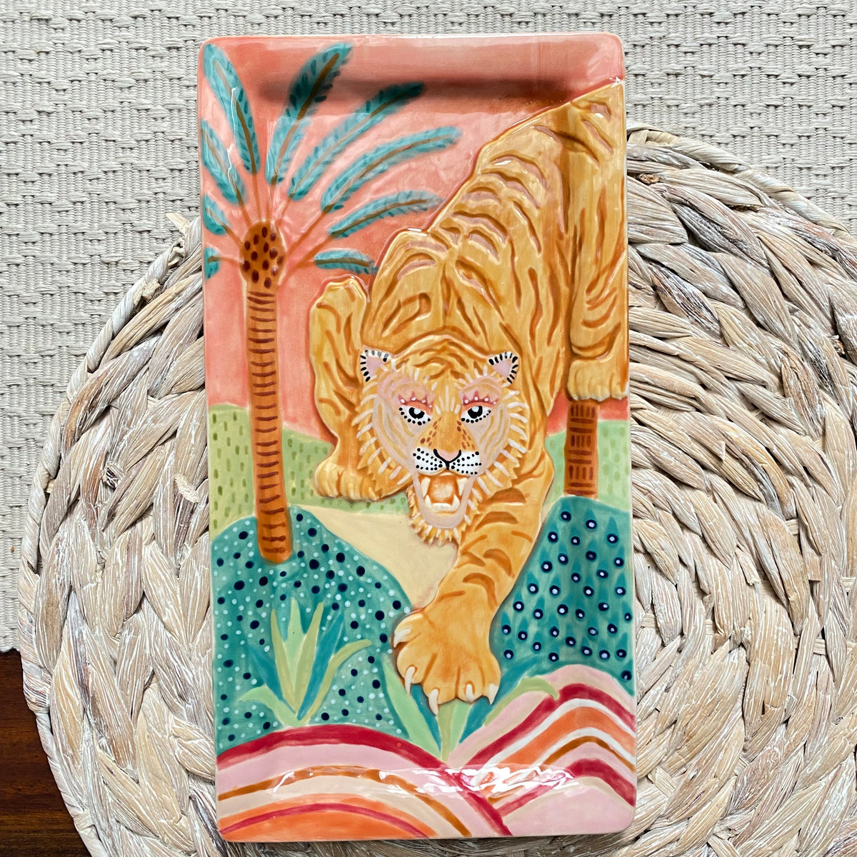 Decorative tray with a tiger design on a woven surface