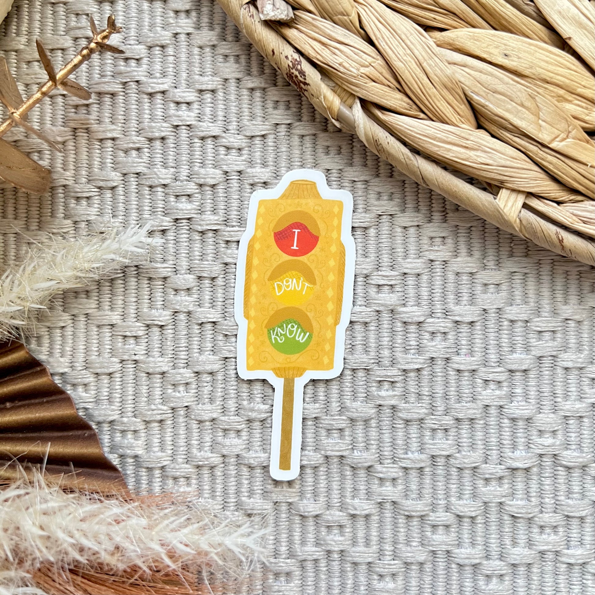 Sticker resembling a traffic light on a textured surface with decorative elements