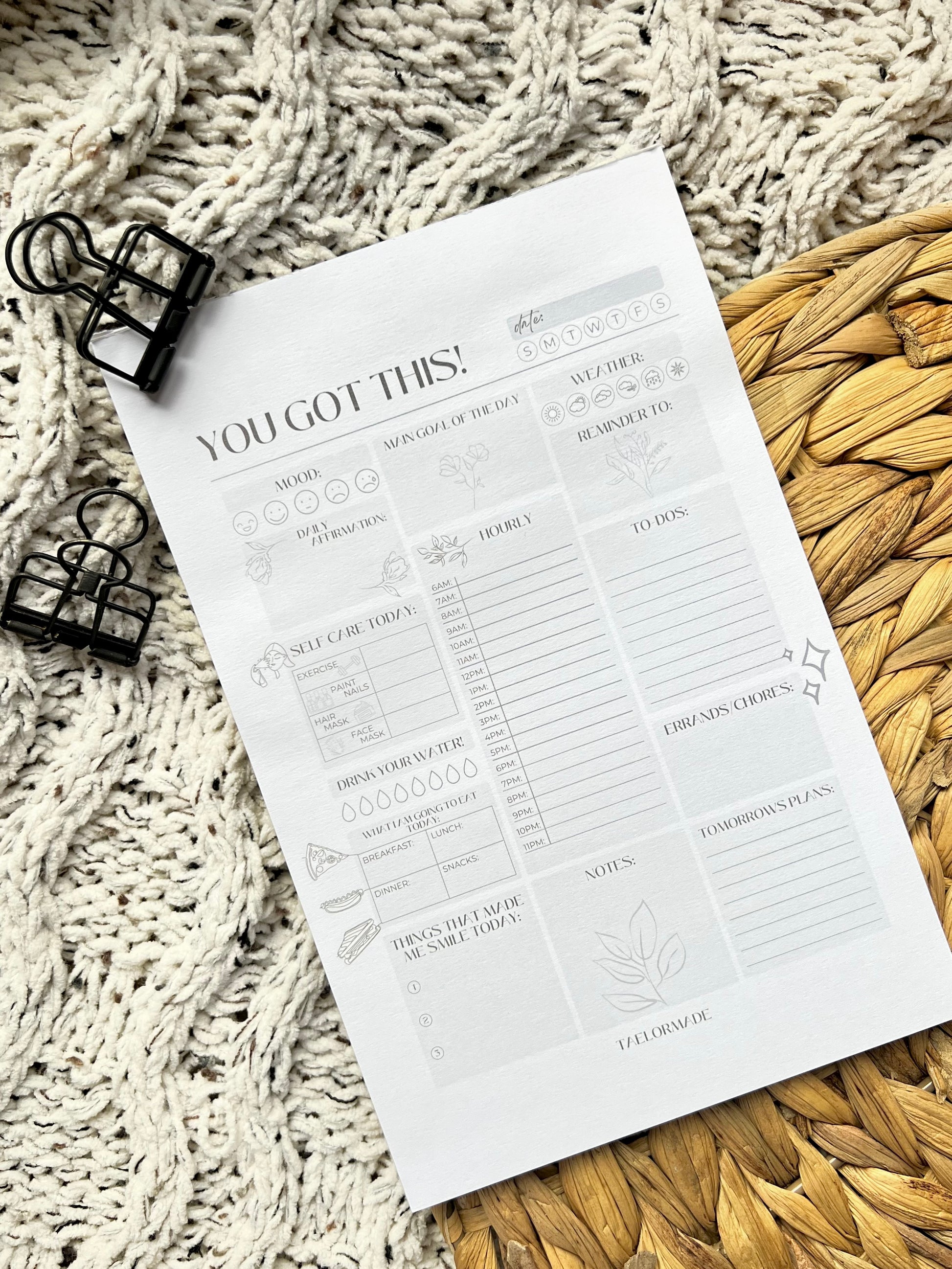 Daily planner notepad with text and icons on a textured surface